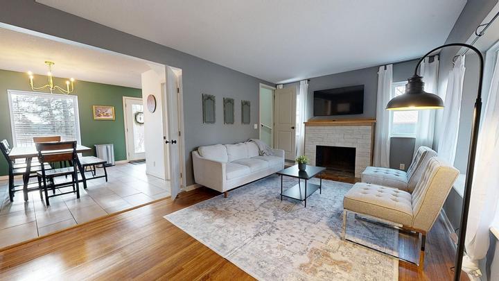 White brick fireplace with a timber mantel in a living room