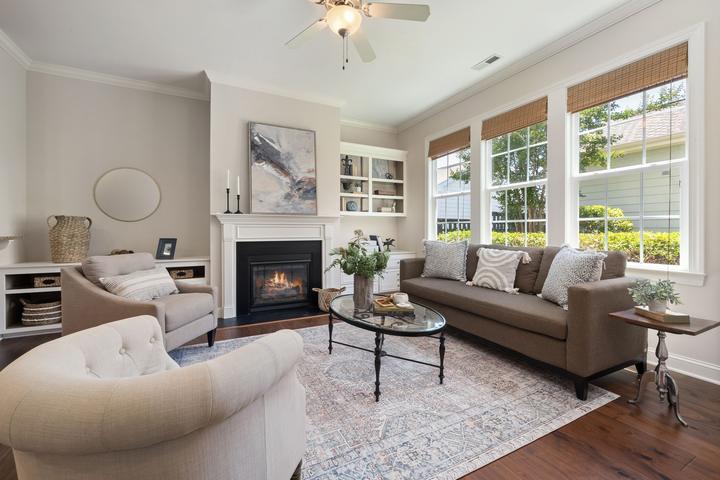 Fireplace with a white surround and dark framed opening in a furnished room